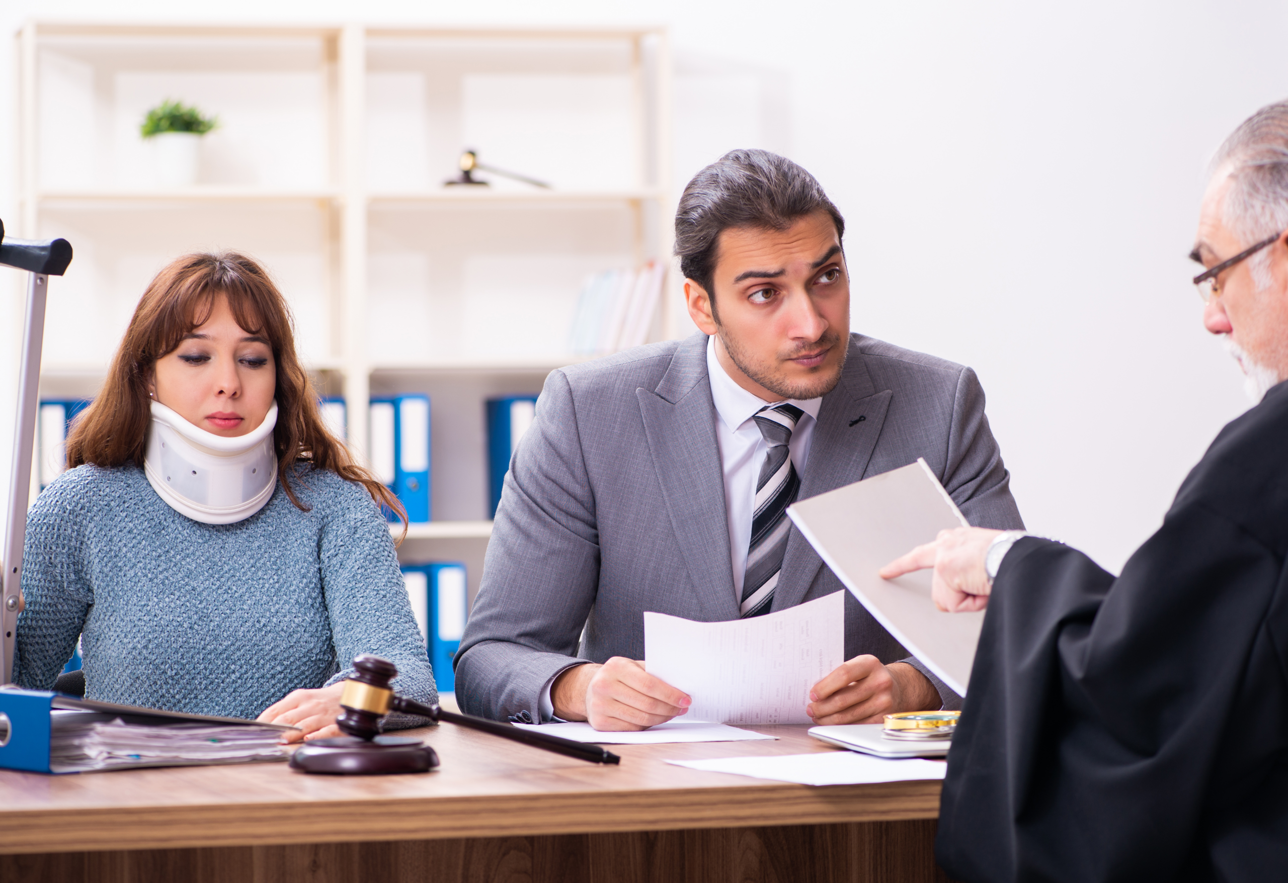 Young woman in courthouse with judge and lawyer